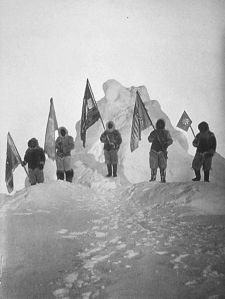 Robert Peary and sledge party with flags at North Pole. Peary has been claimed to be the first person to reach the north pole.